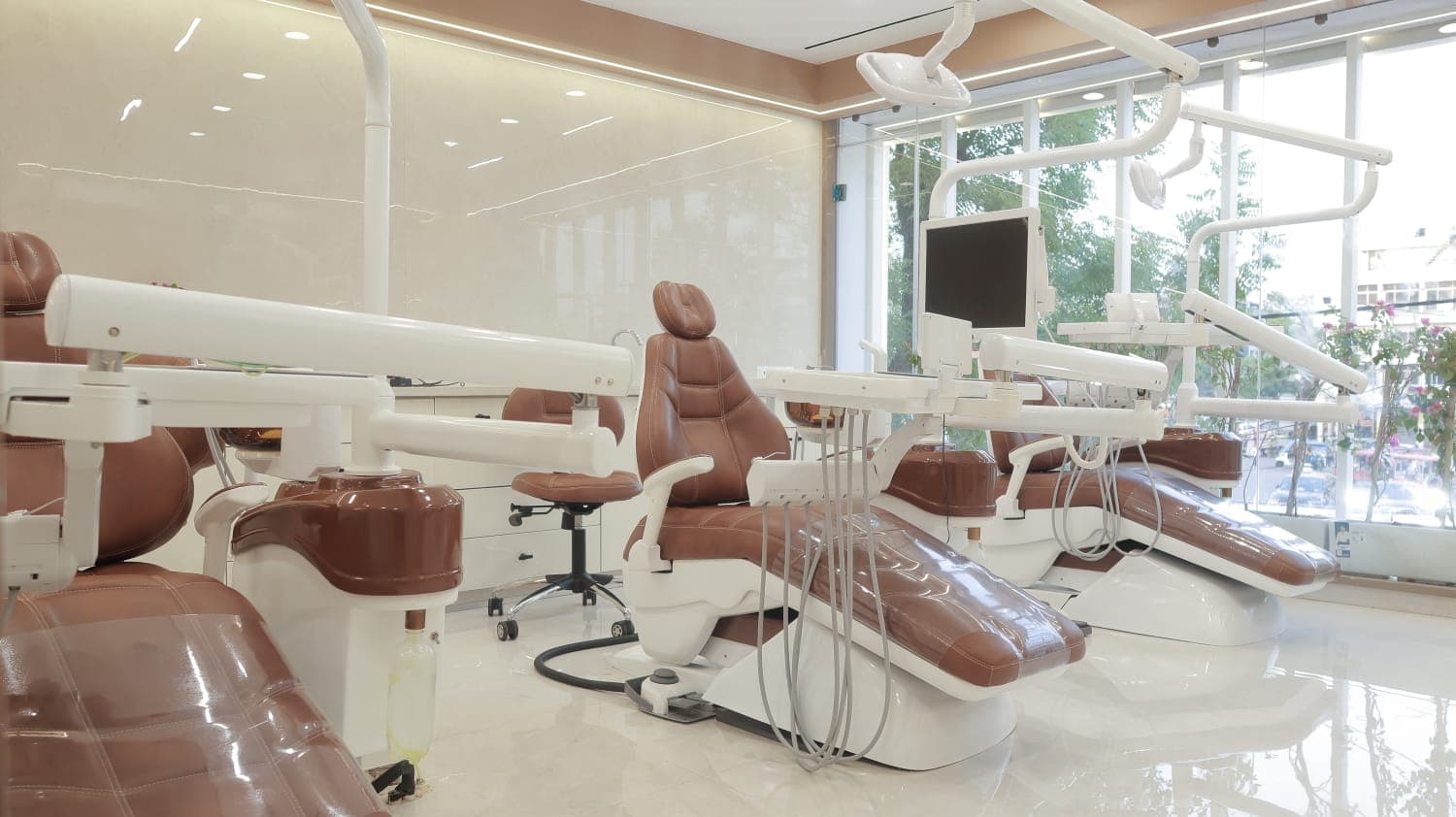 Naturally lit treatment area with dental chairs by the windows